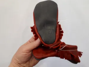 Red leather moccs with short fringe and bows